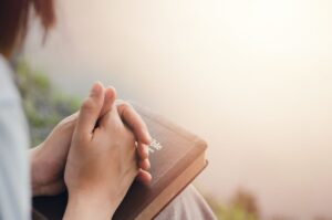 Girl’s,Hand,Sitting,Praying,For,God’s,Blessing,Along,With,Coming