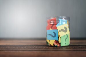 Colorful,Paper,With,Question,Mark,In,A,Plastic,Jar,On