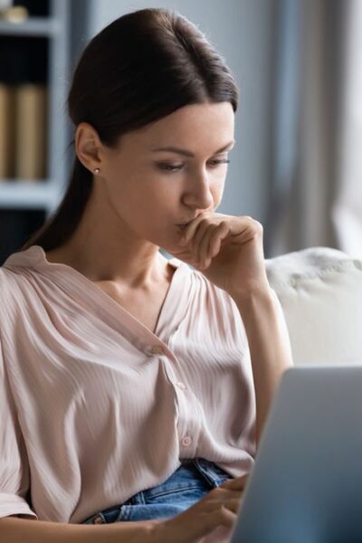 Close,Up,Thoughtful,Upset,Woman,Looking,At,Laptop,Screen,,Pondering